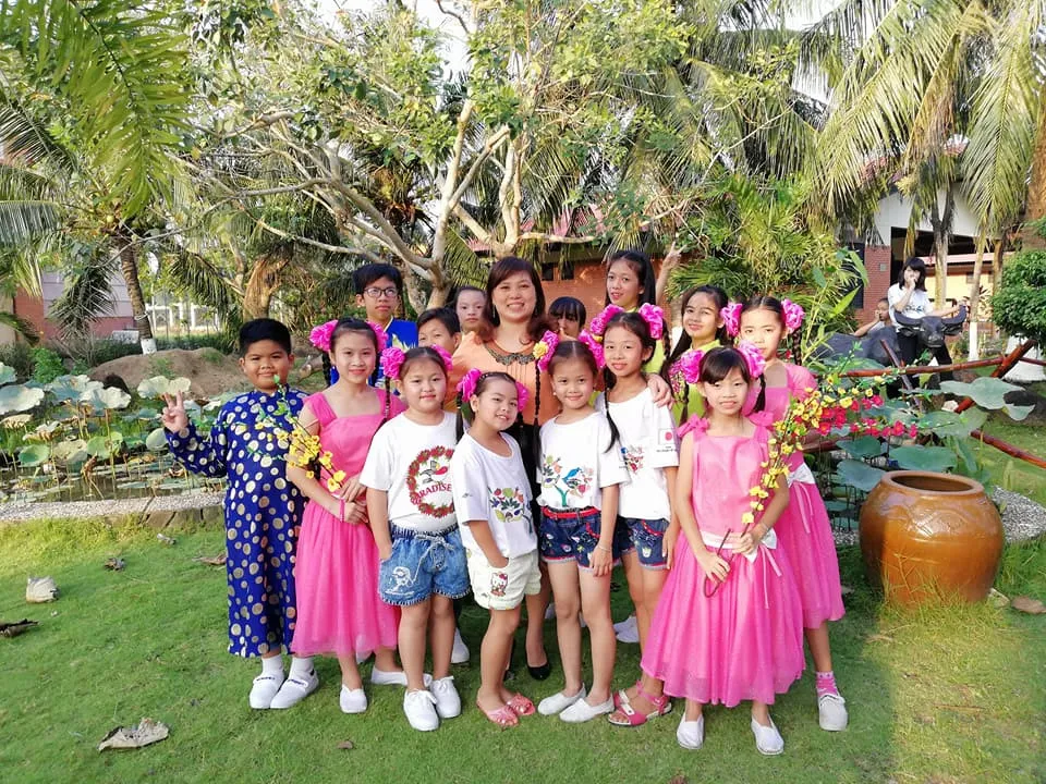 Một gia đình ở Làng trẻ em SOS Bến Tre chụp ảnh cùng nhau trước giờ văn nghệ. Mỗi gia đình ở Làng SOS gồm có một người mẹ chăm sóc nuôi dạy khoảng trên 10 trẻ em. Ảnh: Làng trẻ em SOS Bến Tre SOS ben Tre.jpg