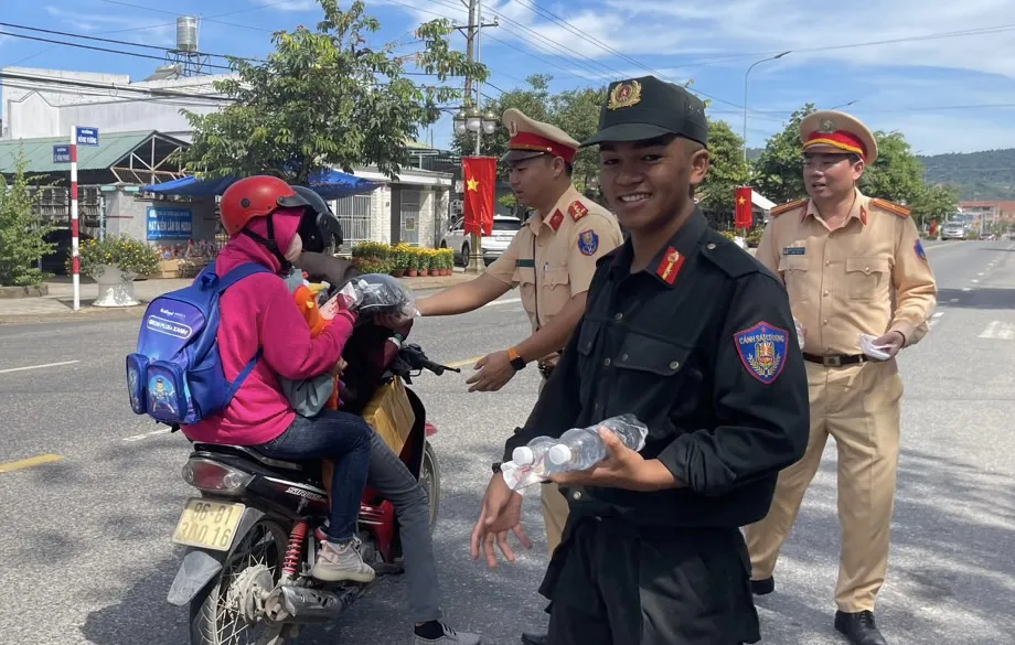Hàng ngàn chai nước suối được phát đến tay người dân đi ngang quốc lộ 20 để vào địa phận tỉnh Lâm Đồng. Ảnh: VÕ TÙNG