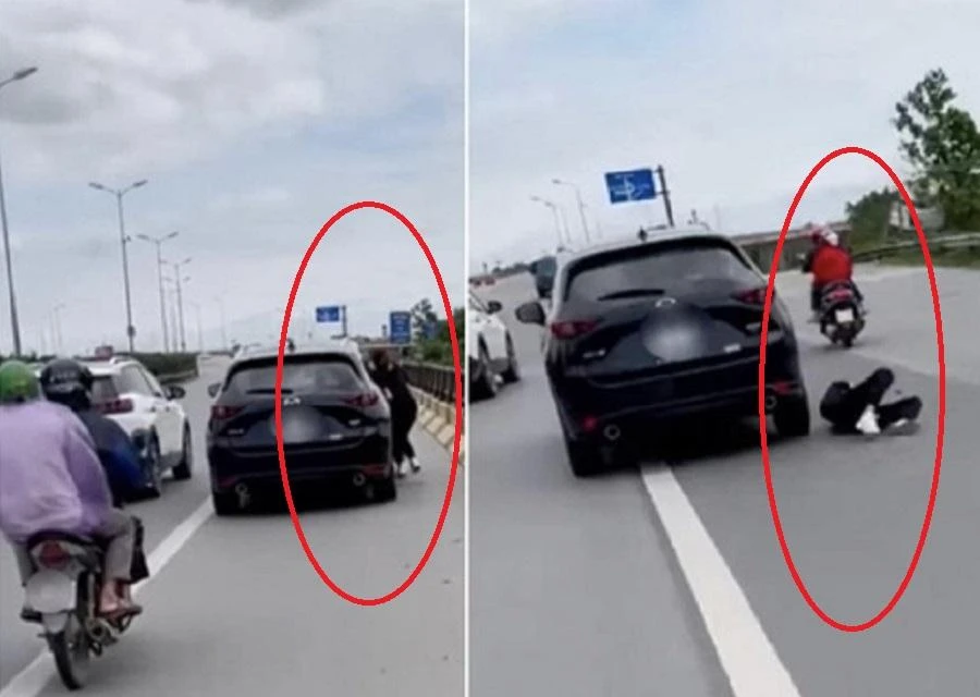 Người chồng nhấn ga để tăng tốc chiếc ô tô, kéo theo người vợ đang đu bám ở hông xe, khiến chị này bị ngã văng xuống đường. Ảnh: Cắt từ clip