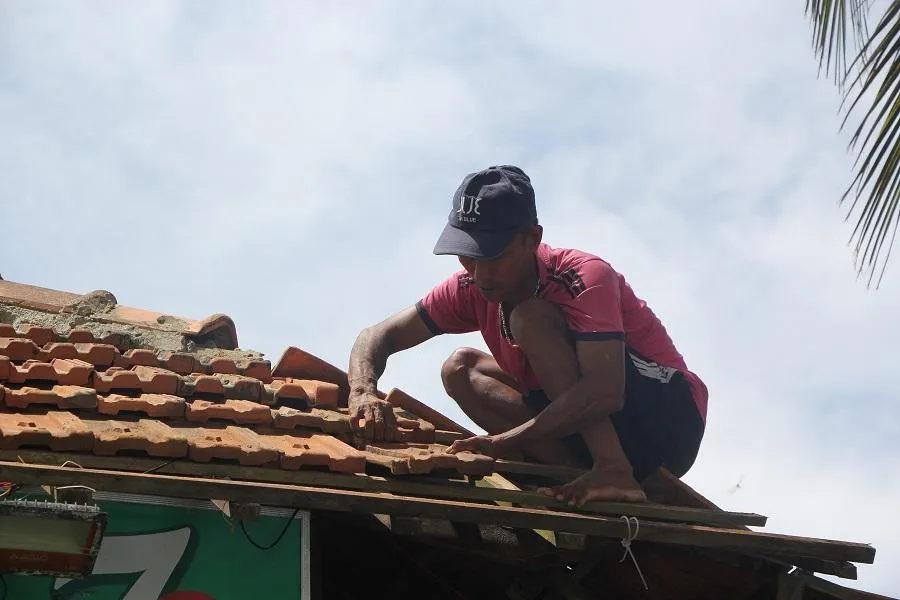 Chồng chị Quế đang sửa lại mái nhà sau bão. Ảnh: NGÔ QUANG Chồng chị Quế đang sửa lại mái nhà sau bão. Ảnh: NGÔ QUANG