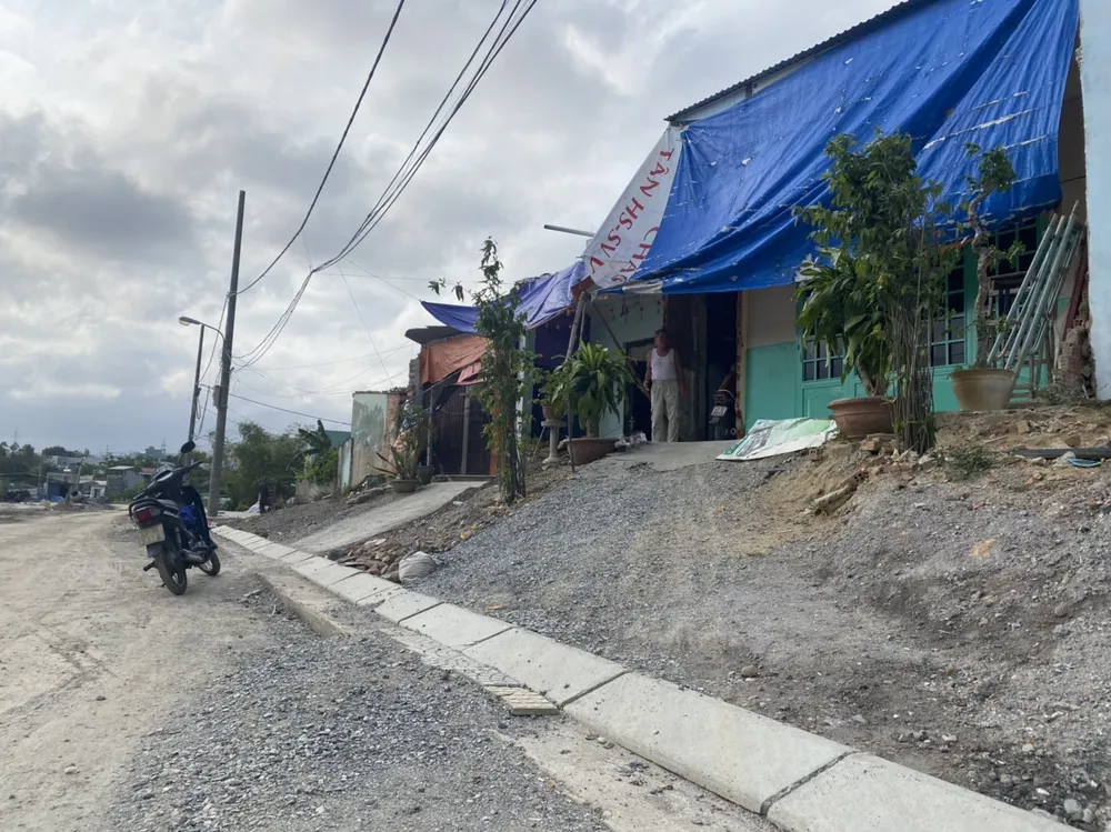 Nhà dân sau khi mở đường thì như ở trên đồi cao.Ảnh: NGÔ QUANG