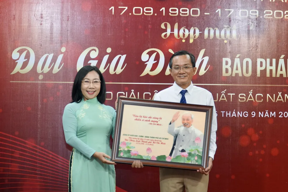 Bà Hàng Thị Thu Nga, Phó Bí thư Đảng uỷ, Đảng uỷ Khối Dân- Chính- Đảng TP.HCM tặng quà cho báo. Ảnh: BẢO PHƯƠNG 33-nam-thanh-lap-bao-Phap-luat-tphcm (2).jpg