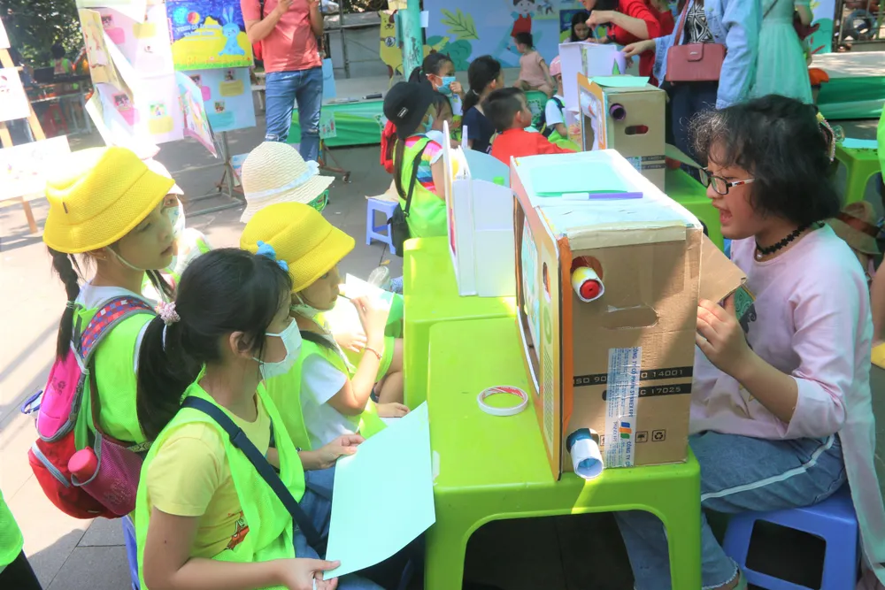 Họa sĩ và dịch giả nhí hướng dẫn các em bé tham quan thế giới sách “Do trẻ em làm - Cho trẻ em đọc”. Ảnh: THẢO PHƯƠNG Họa sĩ và dịch giả nhí hướng dẫn các em bé tham quan thế giới sách “Do trẻ em làm - Cho trẻ em đọc”. Ảnh: THẢO PHƯƠNG