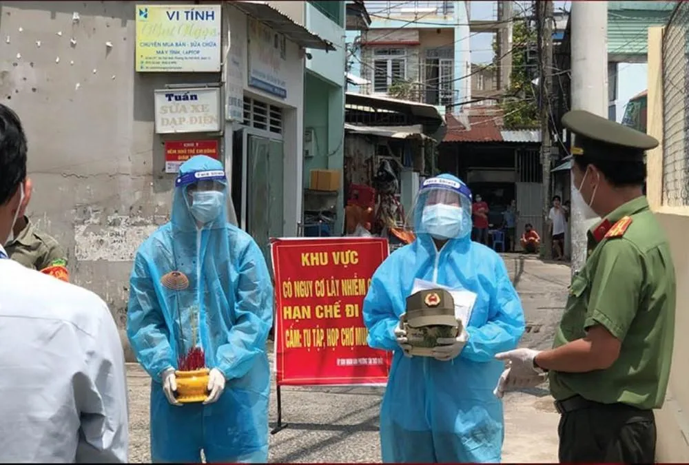 Đan Thanh ôm di ảnh ba, Nhật Hào (18 tuổi) ôm bát hương. Ảnh trưng bày tại triển lãm.