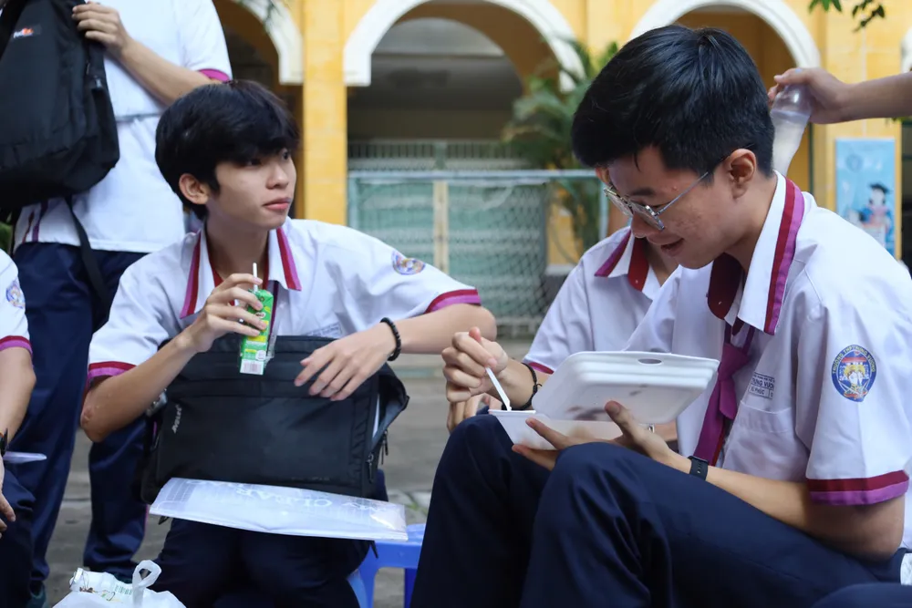 Vũ Phúc, trường THPT Trưng Vương, quận 1 tranh thủ ăn sáng để có năng lượng trong kỳ thi sáng nay. Em chia sẻ, không có hồi họp lo lắng vì đã ôn rất kỹ. Ảnh: TRẦN MINH