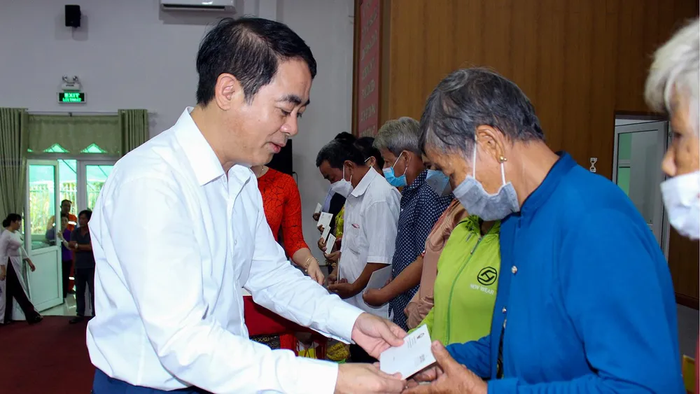 Ông Nghiêm Xuân Thành, Bí thư Tỉnh ủy Hậu Giang tặng quà cho các hộ nghèo ở huyện Phụng Hiệp. Ảnh: TS