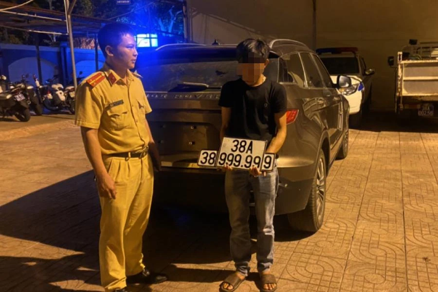 Chủ nhân chiếc xe Zotye Z8 giao nộp biển kiểm soát giả cho cảnh sát. Ảnh: CA