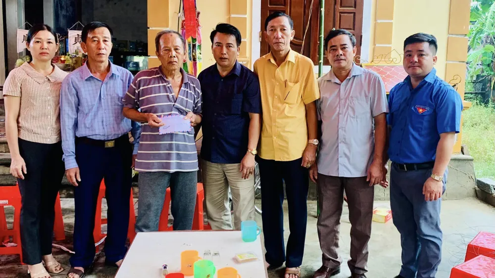 Cán bộ xã Đồng Văn đến thăm hỏi, động viên người thân của chị Thảo.Ảnh: LĐ nghe-an-nuoc-lu-cuon.jpg