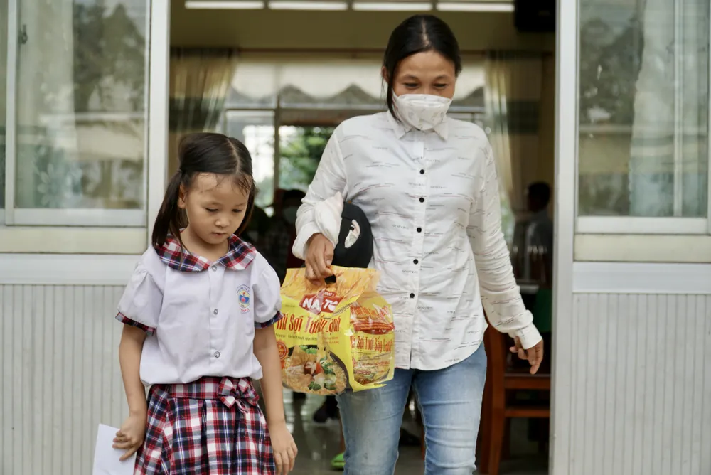 Phụ huynh cùng các em học sinh đến nhận học bổng. Ảnh: BẢO PHƯƠNG