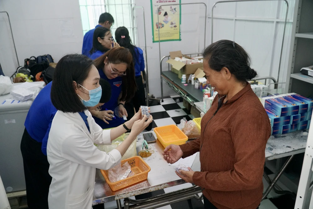 Bà Nguyễn Thị Vân (ngụ ấp Thiềng Liềng) đo huyết áp và nhận thuốc miễn phí. Ảnh: BẢO PHƯƠNG xa-dao-thanh-an-6.JPG
