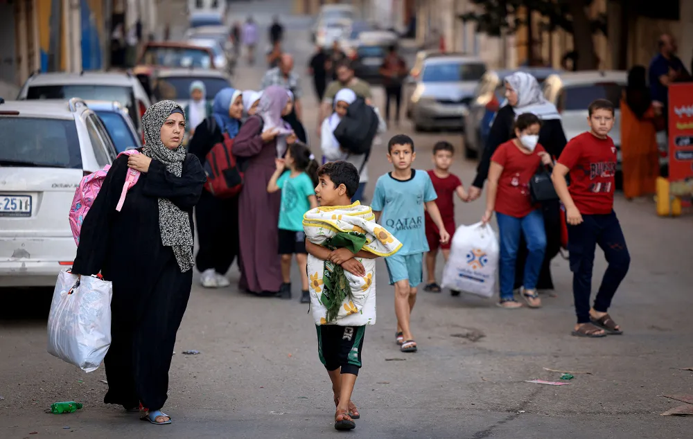 Người dân ở Dải Gaza mang đồ đạc tìm nơi trú ẩn sau trận không kích của Israel hôm 13-10. Ảnh: AFP 5fb9c899-258a-4b4e-b112-2387a355009d.jpeg