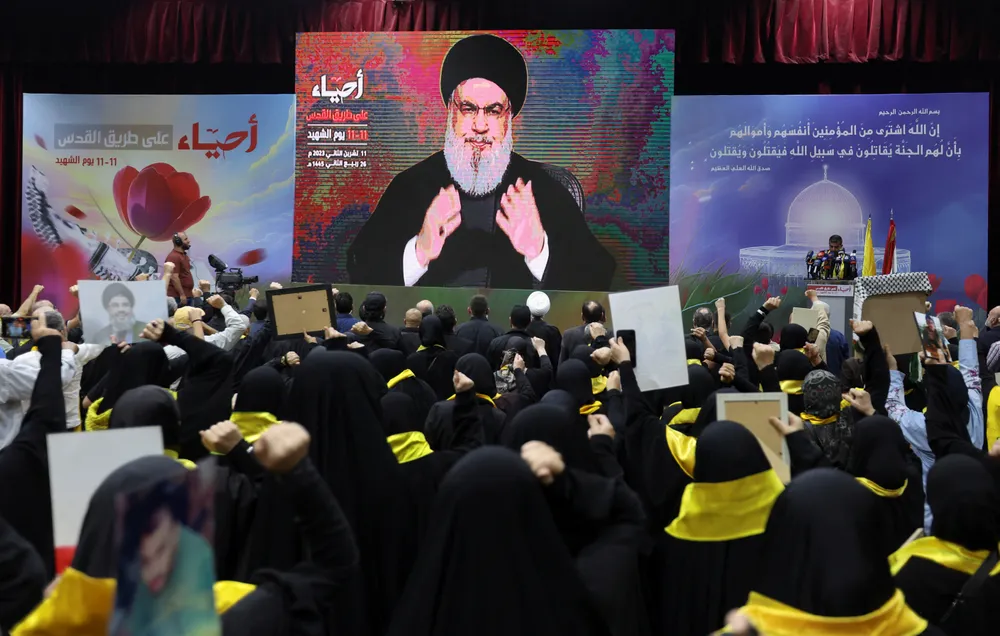 Những người ủng hộ xem lãnh đạo Hezbollah - ông Hassan Nasrallah phát biểu tại Lebanon vào ngày 11-11. Ảnh: REUTERS