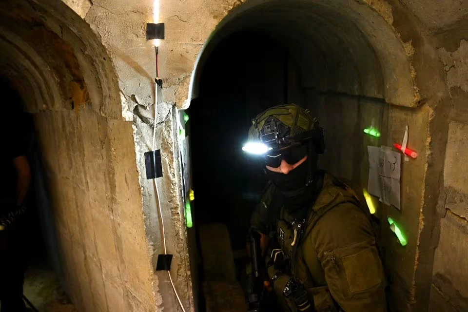 Binh sĩ Israel đi vào đường hầm được cho là của Hamas bên dưới trụ sở cơ quan cứu trợ của Liên Hợp Quốc cho người Palestine ở Gaza. Ảnh: REUTERS Đường hầm.png
