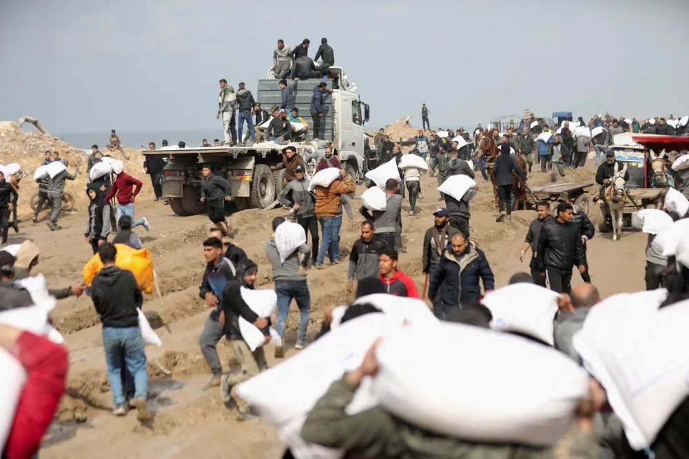 Người dân Gaza nhận viện trợ gần khu vực trạm kiểm soát của Israel tại TP Gaza (bắc Gaza) trong bối cảnh xung đột Israel-Hamas vẫn tiếp diễn. Ảnh: REUTERS X3LUZSN77ZPQNP57JHVQONUOWQ.jpg