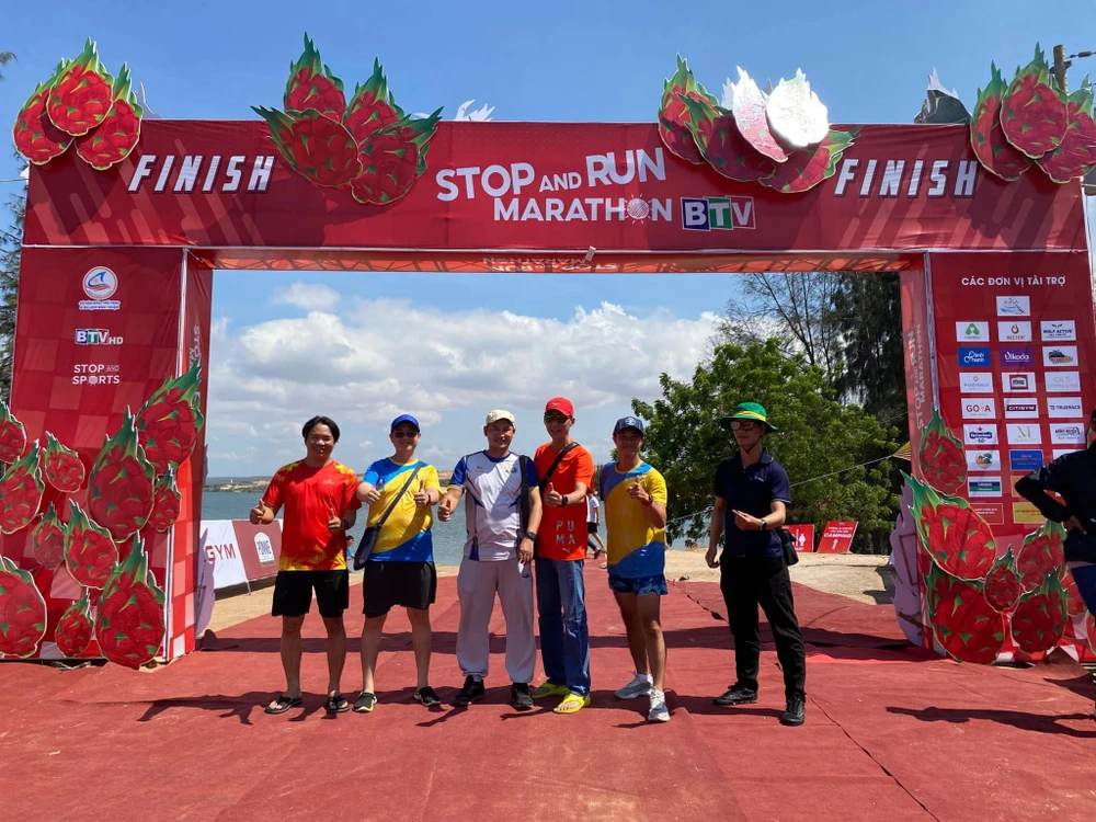 Các runner thích thú tạo dáng bên cổng xuất phát và về đích của Stop And Run Marathon Bình Thuận 2024. Ảnh: VT. dac-san-vung-bien-tai-giai-chay-stop-and-run-marathon-binh-thuan (3).jpg