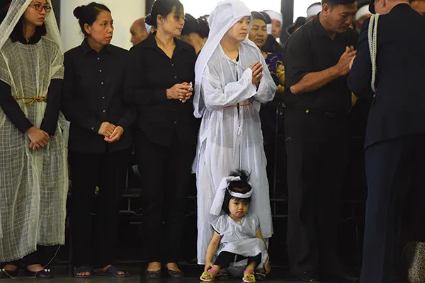 Con gái nhỏ hơn 2 tuổi của trung tá Lê Văn Đình, nhân viên tuần thám trên không ngồi bệt dưới chân mẹ.