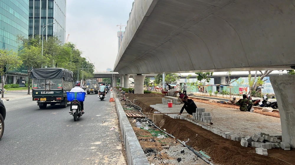 Các công nhân đang lát gạch, thảm nhựa. Ảnh: ĐT. Các công nhân đang lát gạch, thảm nhựa. Ảnh: ĐT.