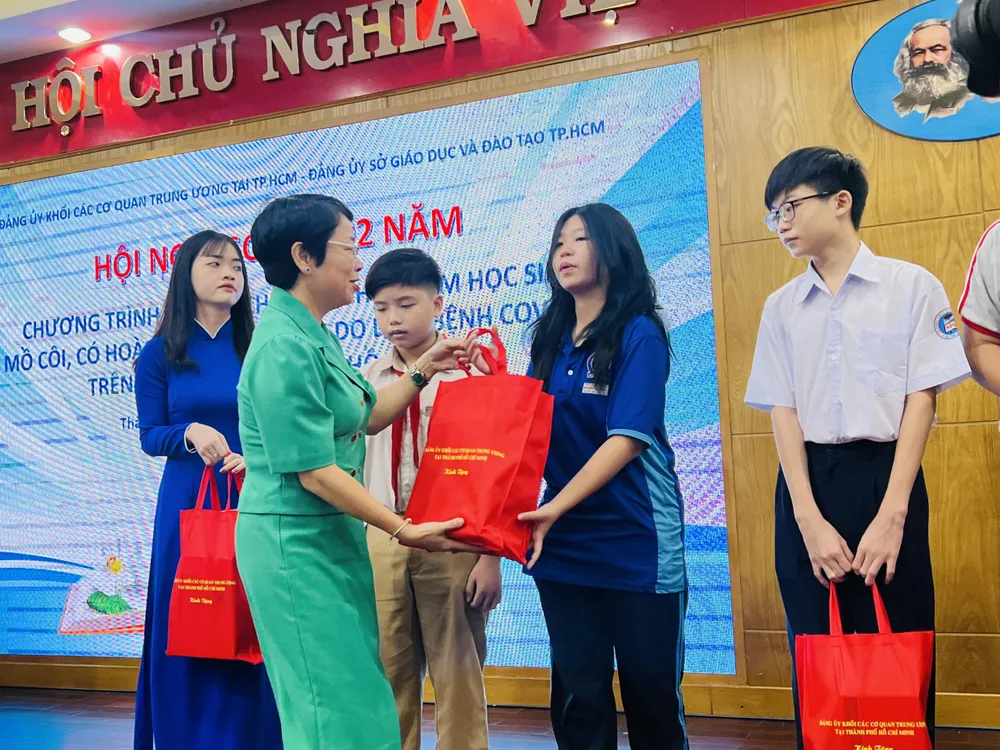 Bà Nguyễn Thị Hải Yến - Thành viên Hội đồng quản trị Tổng Công ty Phát điện 3 trao quà cho các em học sinh. Ảnh: ĐT