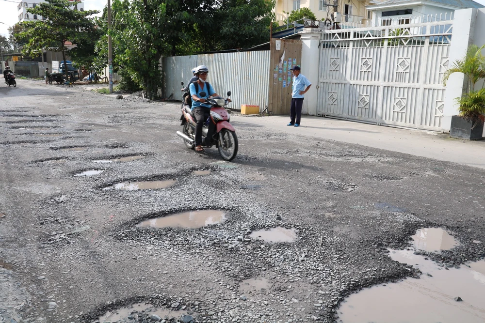 Hàng loạt ổ gà xếp hàng trên đường Bưng Ông Thoàn. duong-xuong-cap