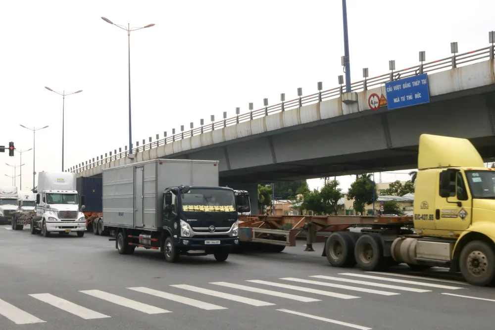 Nhiều phương tiện vận tải thay đổi hướng đi sau thông báo cấm lên cầu sáng 27-7. Ảnh: LAN HƯƠNG. IMG_8840.jpg