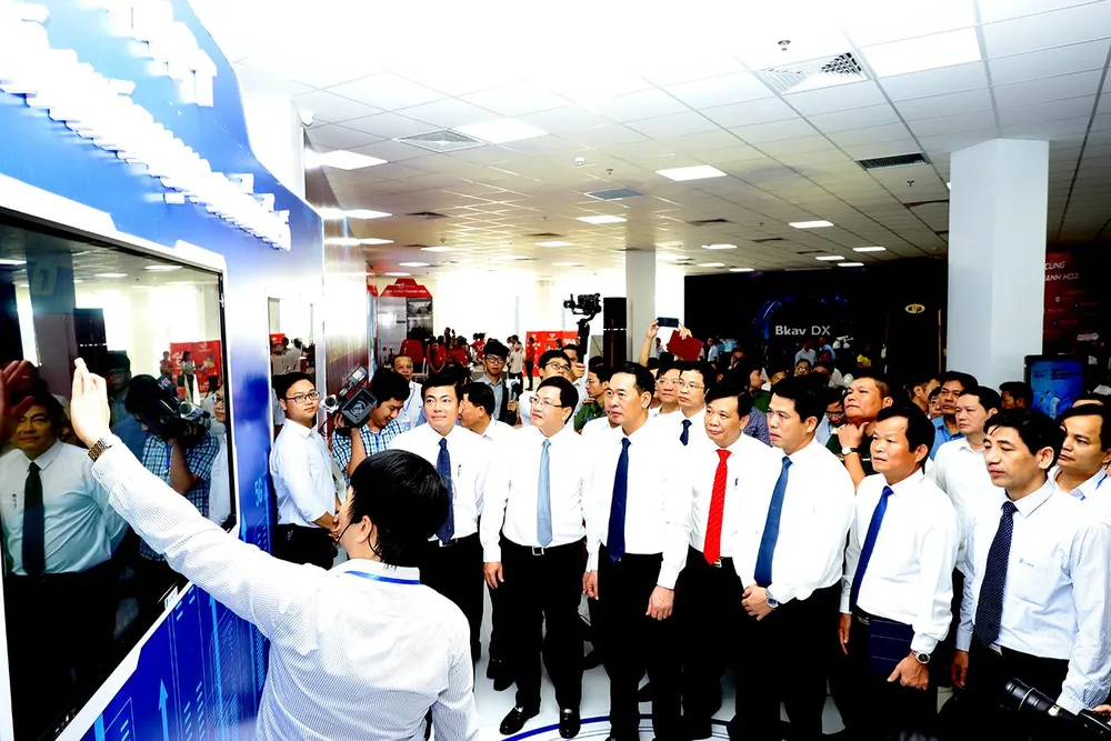 Lãnh đạo UBND tỉnh Thanh Hóa, Bộ TT&amp;TT cùng các đại biểu thăm quan các gian hàng trưng bày các sản phẩm, giải pháp, mô hình chuyển đổi số. Ảnh: ĐẶNG TRUNG