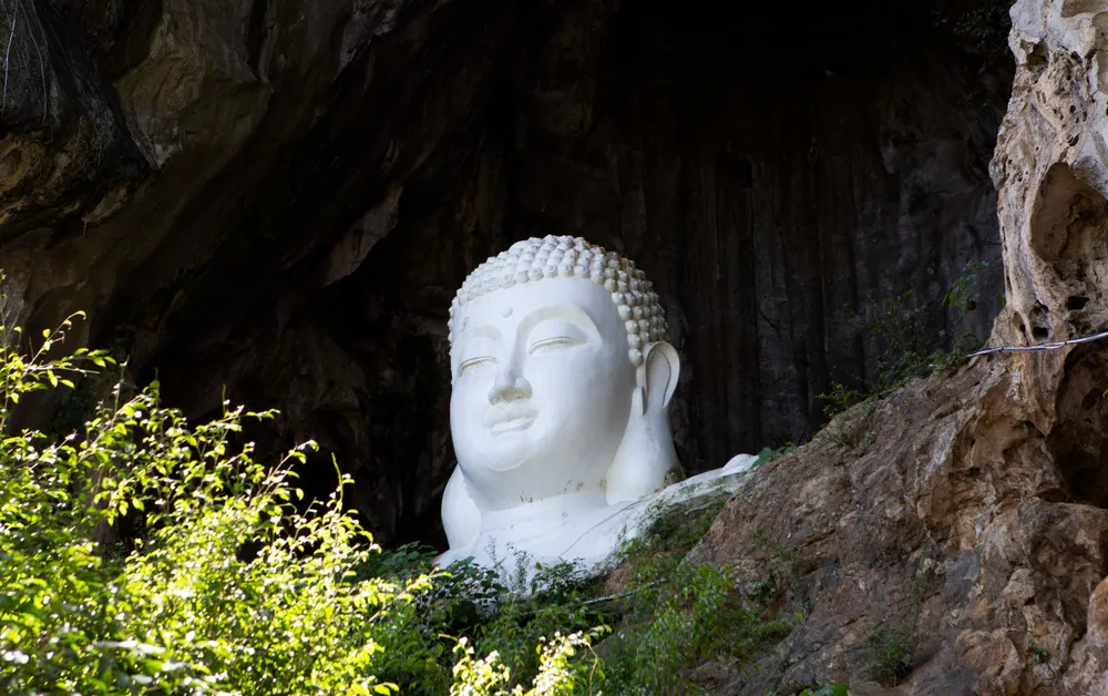 Bức tượng phật lớn tựa vào lưng núi nhìn ra dòng suối Ấu mang lại cảm giác bình yên cho du khách thập phương đến vãn cảnh chùa. Ảnh: ĐẶNG TRUNG