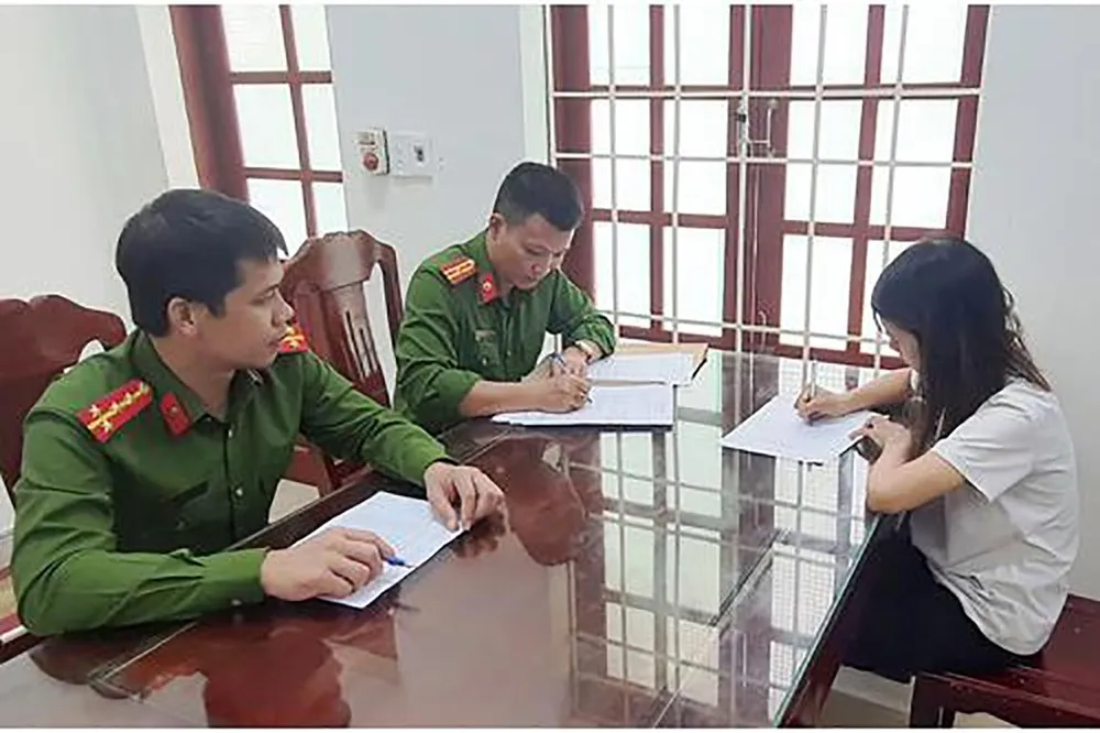 Nguyễn Thị Minh tại cơ quan công an. Ảnh: CATH