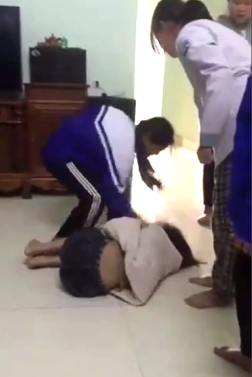Nữ sinh TTYN sau khi bị đánh ngất xỉu thì được nhóm học sinh chườm đá, mua sữa cho uống xong rồi đánh tiếp. Ảnh: Cắt ra từ clip