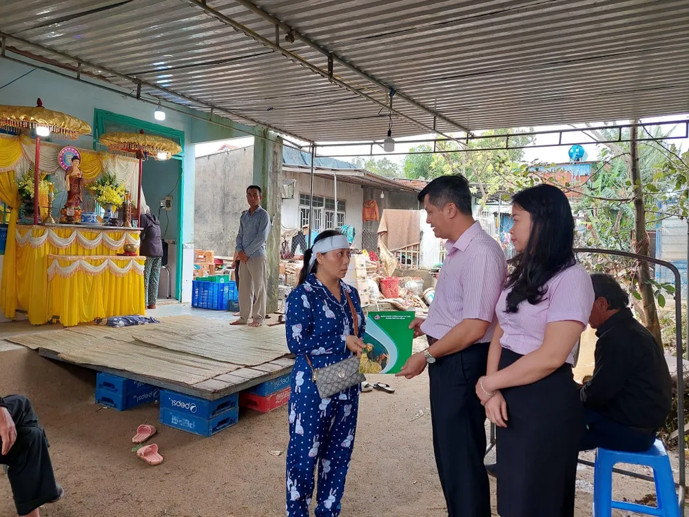 Ông Đoàn Ngọc Chung, Giám đốc Chi nhánh NHCSXH TP Đà Nẵng và lãnh đạo công đoàn cơ sở thăm hỏi gia đình có người mất trong mưa lũ vào tối 14-10.