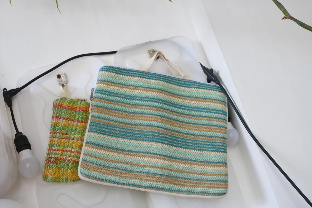 Những bao nilon đem đến sẽ được dệt thành những chiếc túi đựng laptop, bóp viết,…đầy màu sắc. Ảnh: NGỌC TRĂM