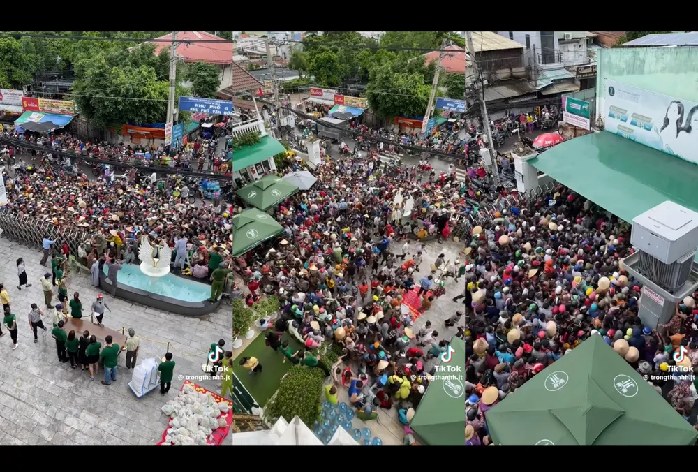 Hàng trăm người tập trung trước cổng một doanh nghiệp trên đường An Dương Vương, phường 13, quận 6 rồi phá cổng lao vào bên trong để nhận quà. Ảnh cắt từ clip