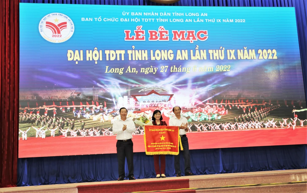 Chủ tịch UBND tỉnh Long An - Nguyễn Văn Út và Trưởng Ban Tổ chức tỉnh Ủy - Lê Thanh Nghiêm tặng cờ thi đua xuất sắc cho đơn vị huyện Cần Giuộc