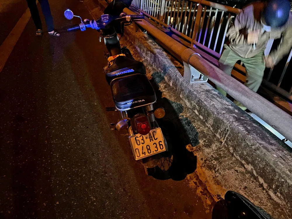 Chiếc xe máy được để lại trên cầu Rạch Miễu. Ảnh: KIM HƯỚNG Chiếc xe máy được để lại trên cầu Rạch Miễu. Ảnh: KIM HƯỚNG