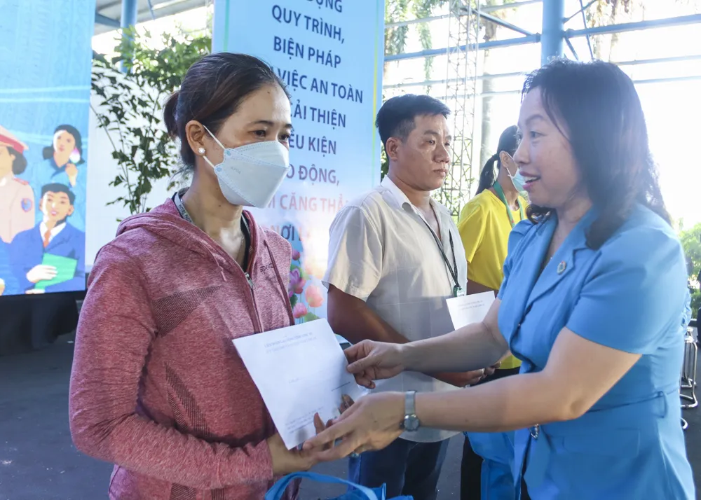 Bà Thái Thu Xương, Phó Chủ tịch Tổng LĐLĐ Việt Nam, trao quà cho công nhân, lao động gặp khó khăn. Ảnh: HUỲNH DU