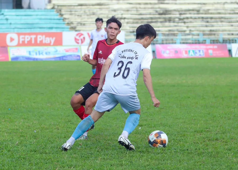 Các cầu thủ Cần Giuộc ( áo trắng) nỗ lực tấn công nhưng không thể xuyên thủng hàng phòng thủ Kiến Tường. Ảnh: HUỲNH DU