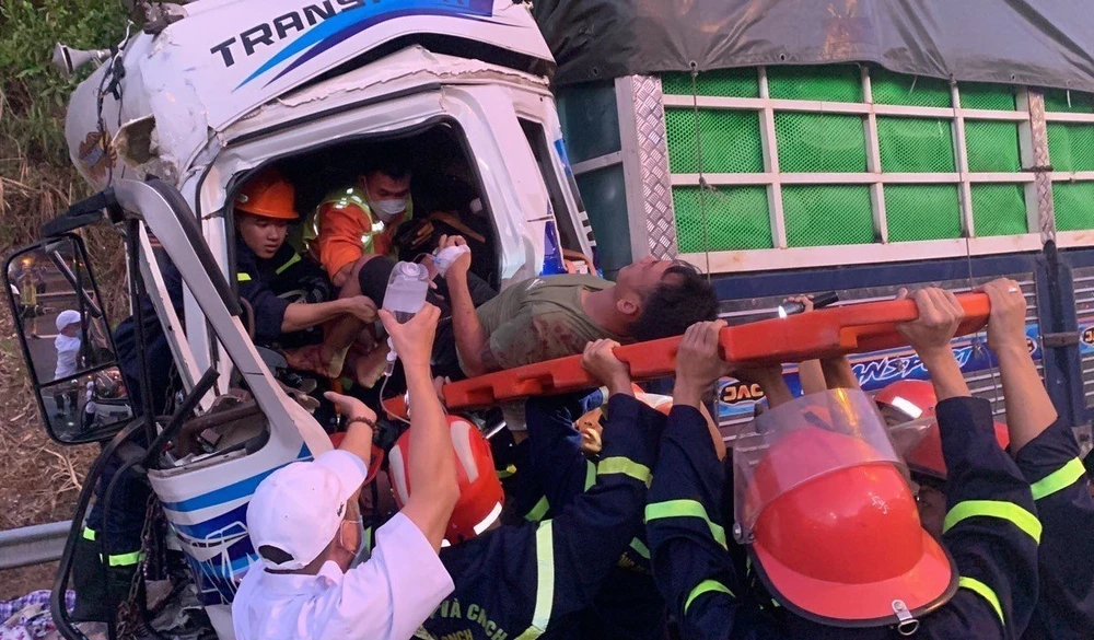 Cảnh sát giải cứu tài xế đưa ra ngoài. Ảnh: H.H