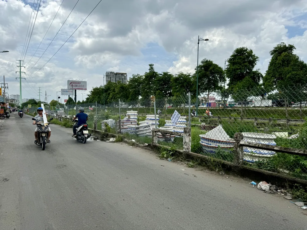 Người dân để đồ phía bên trong hàng rào bằng lưới B40. Ảnh: HUỲNH THƠ IMG_2703.jpeg