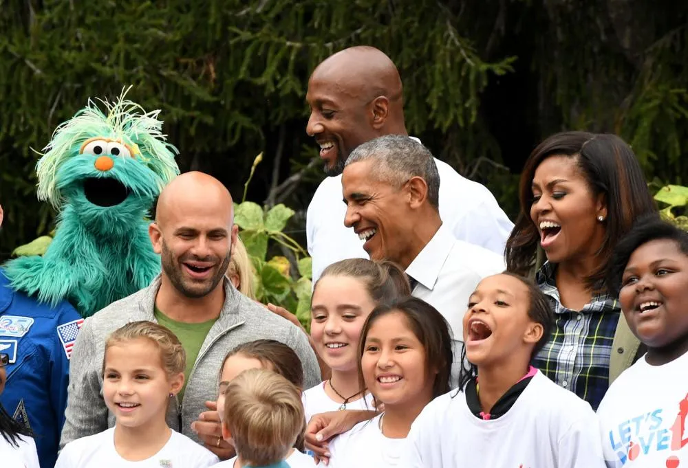 Vợ chồng Tổng thống Obama chụp hình chung với các thành viên tham gia buổi thu hoạch. 