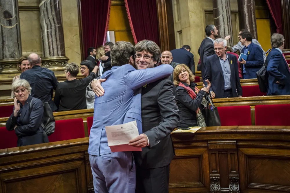 Thủ hiến Catalonia Carles Puigdemont (phải) sau cuộc bỏ phiếu độc lập của nghị viện Catalonia chiều 27-10. Ảnh: BLOOMBERG