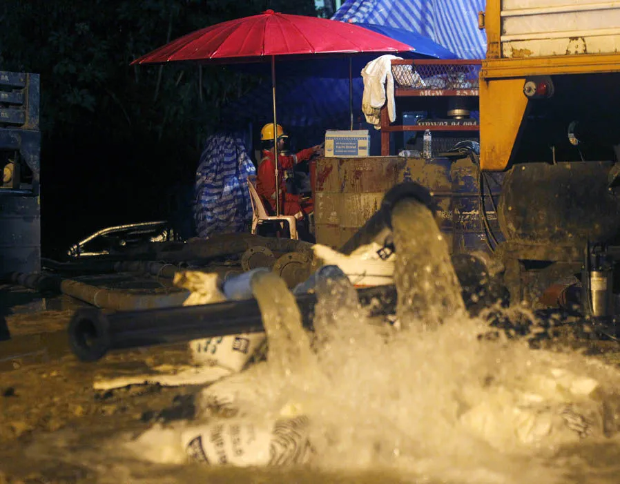 Bơm nước ra khỏi hang động vẫn đang là công việc chính của lực lượng cứu hộ. Ảnh: BANGKOK POST