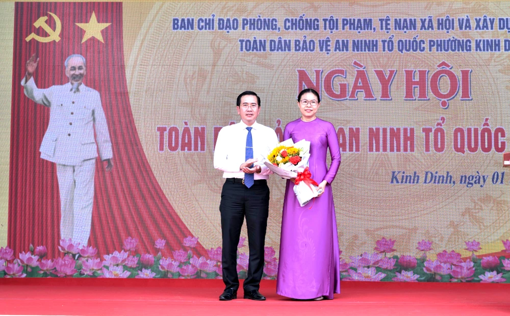 Ông Phạm Văn Hậu tặng hoa chúc mừng lãnh đạo UBND phường Kinh Dinh. Ảnh: X.N