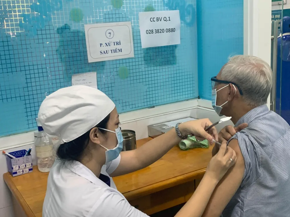 Ông Phí Quang Trung tiêm mũi 4 vaccine COVID-19 tại trạm y tế phường Đa Kao, quận 1. Ảnh: HOÀNG LAN