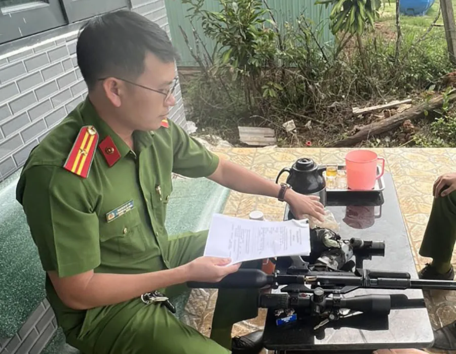 Thiếu tá Nguyễn Sỹ Tý vận động người dân giao nộp súng thể thao, tự chế. Ảnh: V.TÙNG