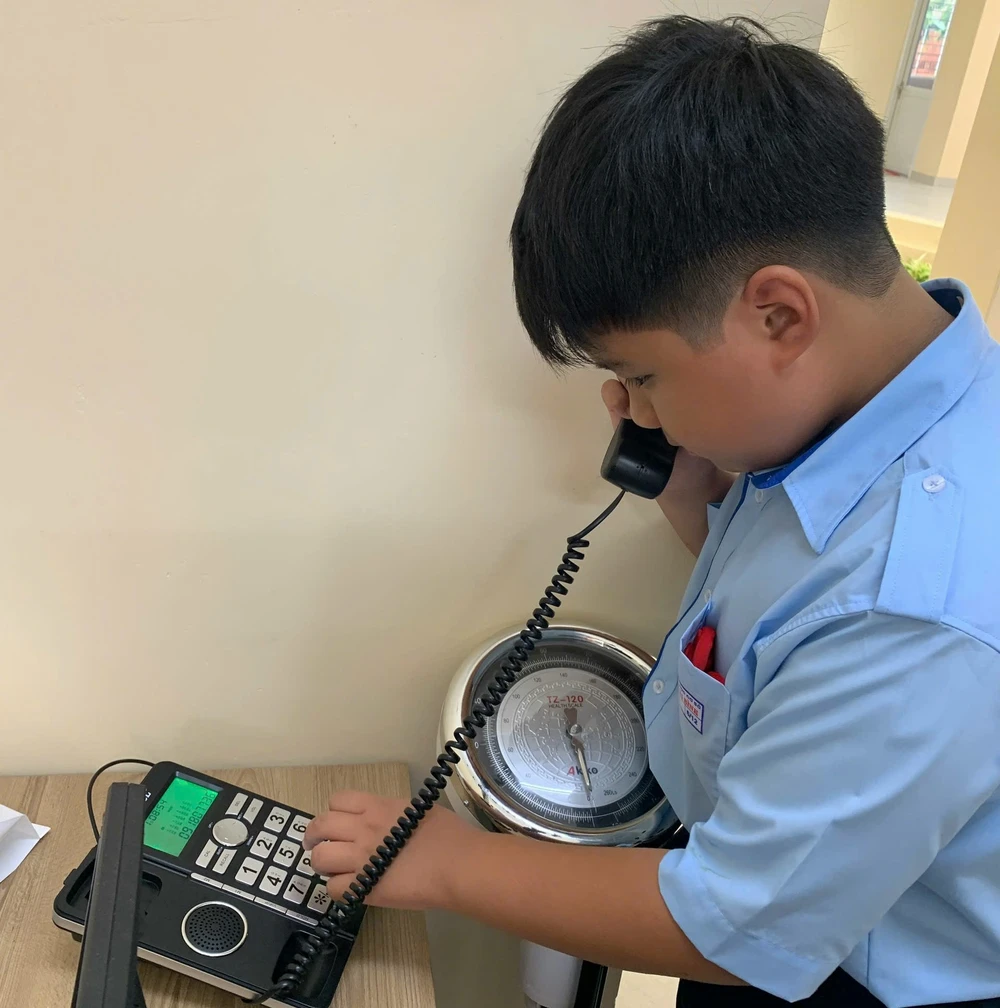 Em Đức Khải, học sinh Trường THCS Nguyễn Thái Bình, gọi điện thoại cho phụ huynh nhờ mang sách vào do để quên. Ảnh: TN P13_dien-thoai_h1_24-9.jpg