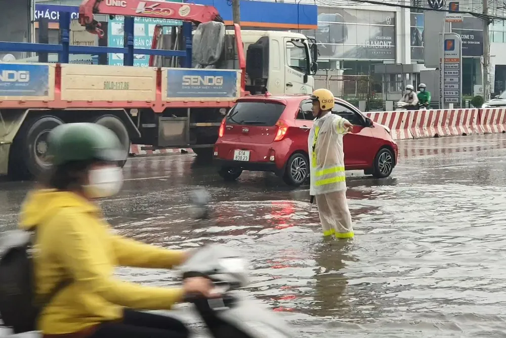 Lực lượng cảnh sát giao thông nỗ lực điều tiết giao thông trên tuyến đường bị ngập. Ảnh: LA Lực lượng cảnh sát giao thông nỗ lực điều tiết giao thông trên tuyến đường bị ngập. Ảnh: LA