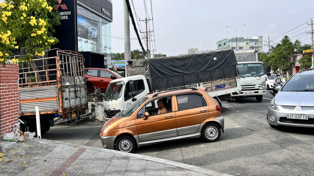 Các phương tiện nối đuôi nhau, xếp hàng dài trước Trung tâm đăng kiểm xe cơ giới 61.01S nằm trên Đại lộ Bình Dương (TP Thủ Dầu Một). Ảnh: LÊ ÁNH