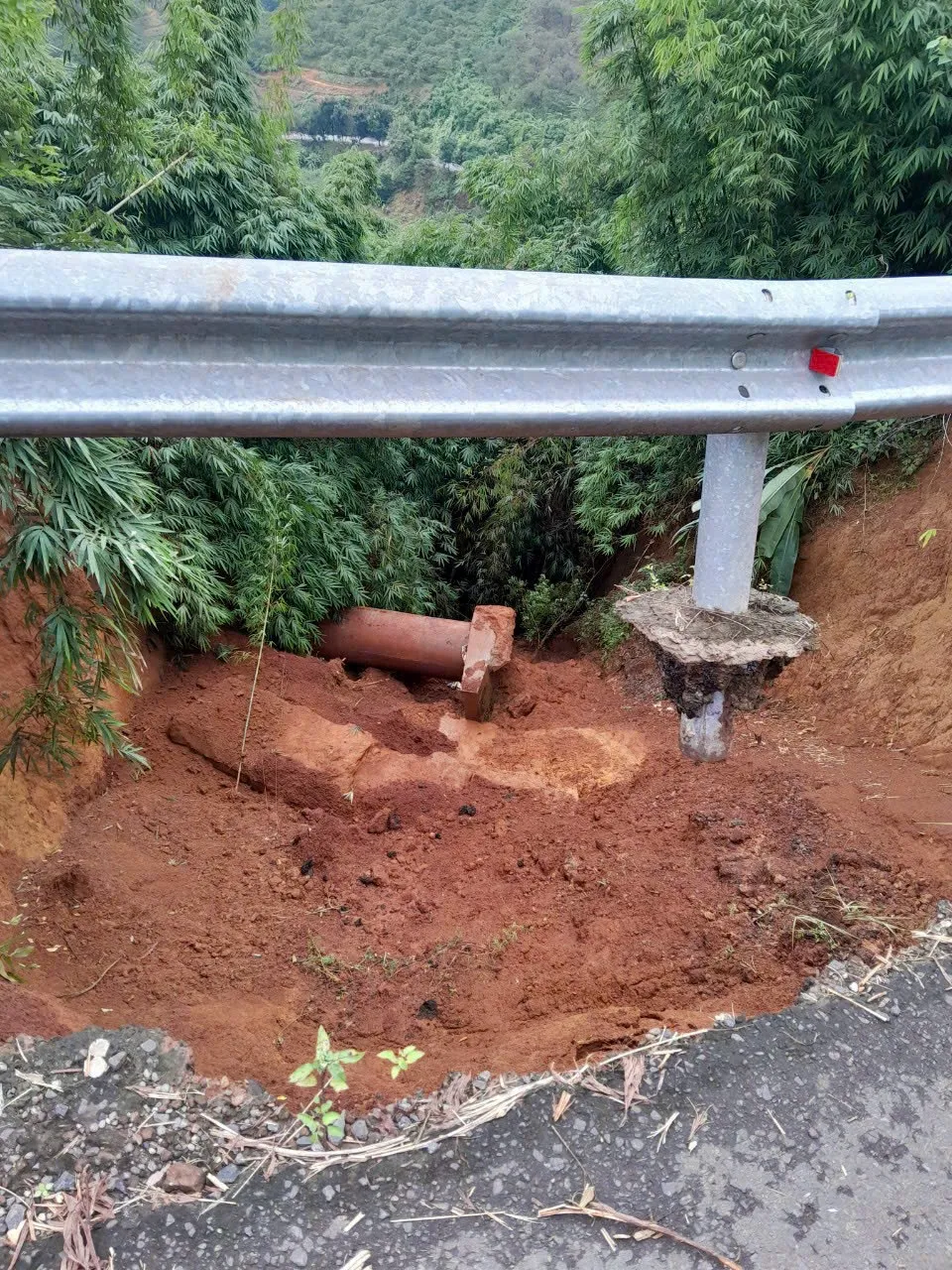 Sạt lở sâu khiến các cột rào chắn bên đường trơ chân. Ảnh: VÕ TÙNG Sạt lở sâu khiến các cột rào chắn bên đường trơ chân. Ảnh: VÕ TÙNG