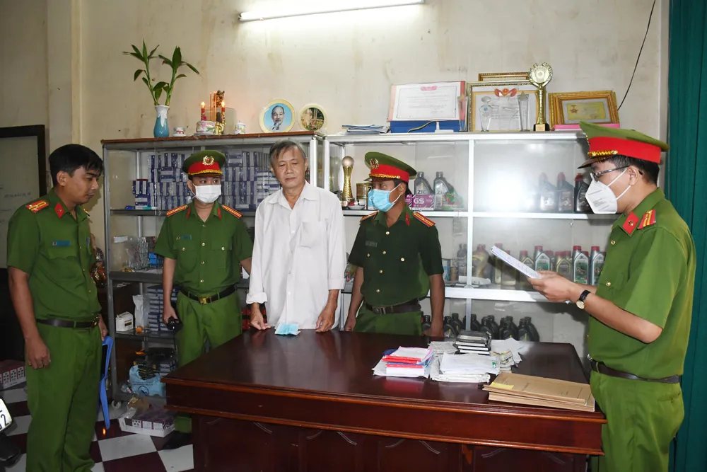 Công an đọc lệnh bắt tạm giam bị can Lê Hùng Quốc. Ảnh: HG