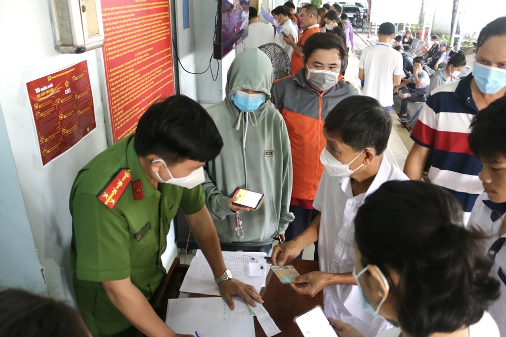 Công an huyện Củ Chi hướng dẫn người dân cài đặt sinh trắc học. Ảnh: H.TUẤN Công an huyện Củ Chi: Không cung cấp mật khẩu ngân hàng cho bất kỳ ai, kể cả nhân viên ngân hàng-sinh-trac-hoc.jpg