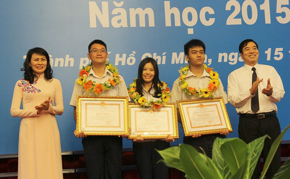 Bà Nguyễn Thị Thu – Phó Chủ tịch UBND TP.HCM (bìa trái) trao bằng khen cho các em Trần Tấn Phát - học sinh lớp 12 Trường THPT Năng khiếu, Nguyễn Hoàng Ngân và Phạm Thanh Trúc - học sinh trường THPT chuyên Lê Hồng Phong.